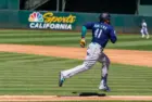 Seattle Mariners infielder Carlos Santana runs to first base against the Oakland Athletics at the Oakland Coliseum. Oakland^ California - August 21^ 2022