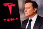 Elon Musk^ CEO of Tesla^ in a formal suit with the Tesla logo in the background. The image depicts electric vehicles^ innovations^ and tech leadership.