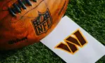 Washington Commanders NFL team Logo and American football ball on Green Grass.