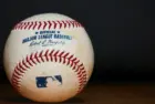 Major League Baseball (MLB) Baseball on black background