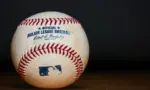 Major League Baseball (MLB) Baseball on black background