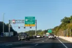Highway i-95 interstate road in Virginia with cars on commute in morning traffic near Washington DC and sign for Prince William Parkway and ManassasWoodbridge^ USA - October 18^ 2021: