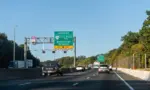 Highway i-95 interstate road in Virginia with cars on commute in morning traffic near Washington DC and sign for Prince William Parkway and ManassasWoodbridge^ USA - October 18^ 2021:
