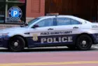 Prince George's County^ Maryland police car sits parked on a street in National Harbor in front of a public parking garage.