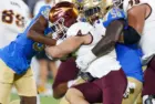 Arizona State running back Cam Skattebo #4 runs against UCLA defensive line Gary Smith III #58 and defensive back Alex Johnson #36 during an NCAA college football game^ Nov. 11^ 2023^ in Pasadena.
