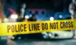 Yellow Tape Showing Text "Police Line Do Not Cross" Restricting a Crime Scene Area At Night. Close Up Aesthetic Shot with Bokeh Effect and Flickering Lights. Criminal on the Loose Strikes Again