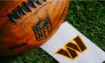 Washington Commanders NFL team Logo and American football ball on Green Grass.