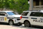 Police patrol cars used by the FBI parked on a street outside the J Edgar Hoover headquarters building in downtown Washington DC. Washington DC^ USA - 30 April 2024