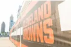 Cleveland Brown's Banner Closeup Leading To The Structural Cityscape Skyline Of Downtown Cleveland. Cleveland^ Ohio/USA - June 1^ 2019