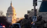 Members of the National Guard patrol the area surrounding the outskirts of the Capitol Building on January 19^ 2021^ in Washington D.C.
