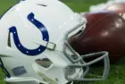 Indianapolis Colts helmet shown on field next to football; Colts host the Oakland Raiders on 9/29/19 at Lucas Oil Stadium in Indianapolis IN-USA