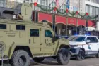 City police^ state police and Homeland Security officers^ and an armored vehicle and state patrol vehicle on Canal Street near the entrance to Bourbon Street New Orleans^ LA^ USA - January 2^ 2025