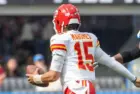 KC Chiefs quarterback Patrick Mahomes #15 runs to escape a tackle by LA Chargers outside linebacker Bud Dupree #48 during an NFL football game at SoFi Stadium^ Aug. 17^ 2024^ in Inglewood^ Calif.