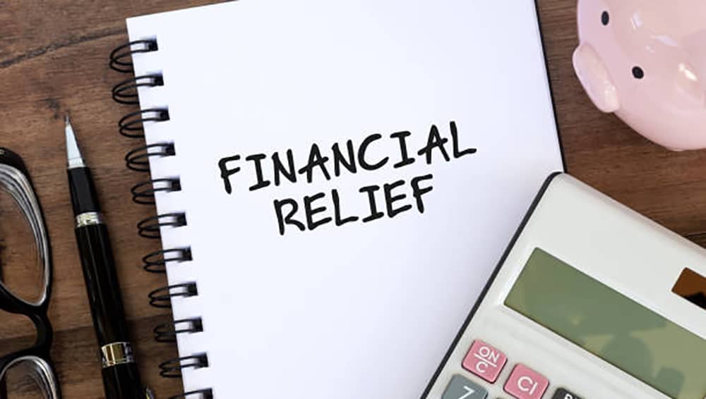 financial-relief-text-on-note-pad-with-calculator-and-piggy-bank