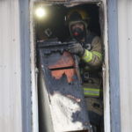fire, Glasgow fire, Dorothy Wood, Dallas Wood, mobile home: Fire crews remove debris from a mobile home along Smiley Court after it caught fire early Wednesday, Jan. 19, 2022.