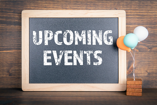 upcoming-events-chalkboard-and-colored-balloons-on-a-wooden-background