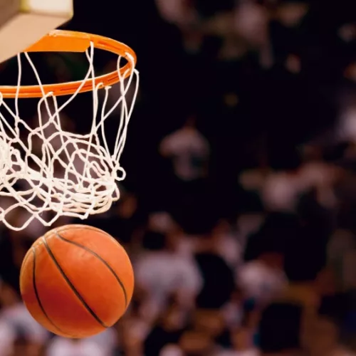 Image of basketball hoop/net with basketball going through/Scoring the winning points at a basketball game