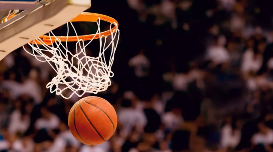 Image of basketball hoop/net with basketball going through/Scoring the winning points at a basketball game
