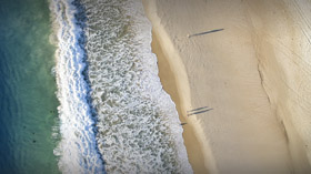 aerial-view-of-beach-ocean-waves-and-people-walking-on-sand-on-gold-coast-beach-2
