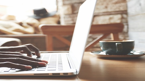 selective-focus-cropped-shot-of-african-american-freelancer-keyboarding-on-laptop-computer-while-wo-2