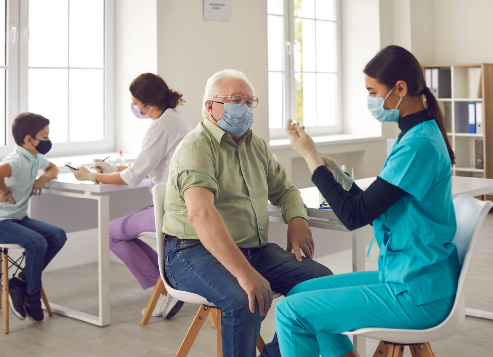 vaccinationforpeopleofdifferentages-asiandoctorgivingflu