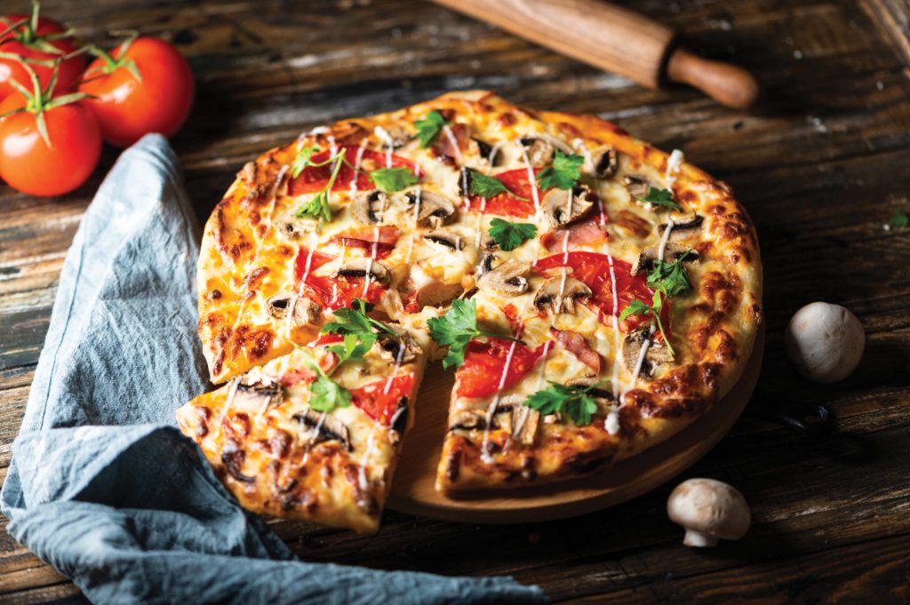 tasty-juicy-pizza-on-wooden-background-lots-of-meat-and-cheese