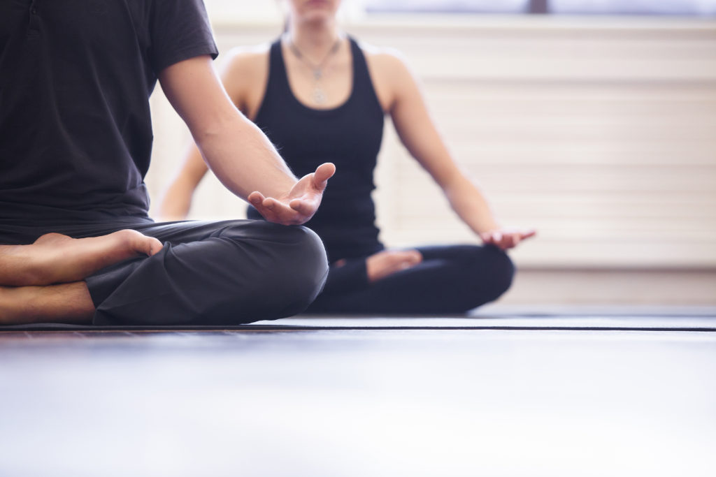 yogagroupconcept-youngcouplemeditatingtogethersittingbackto
