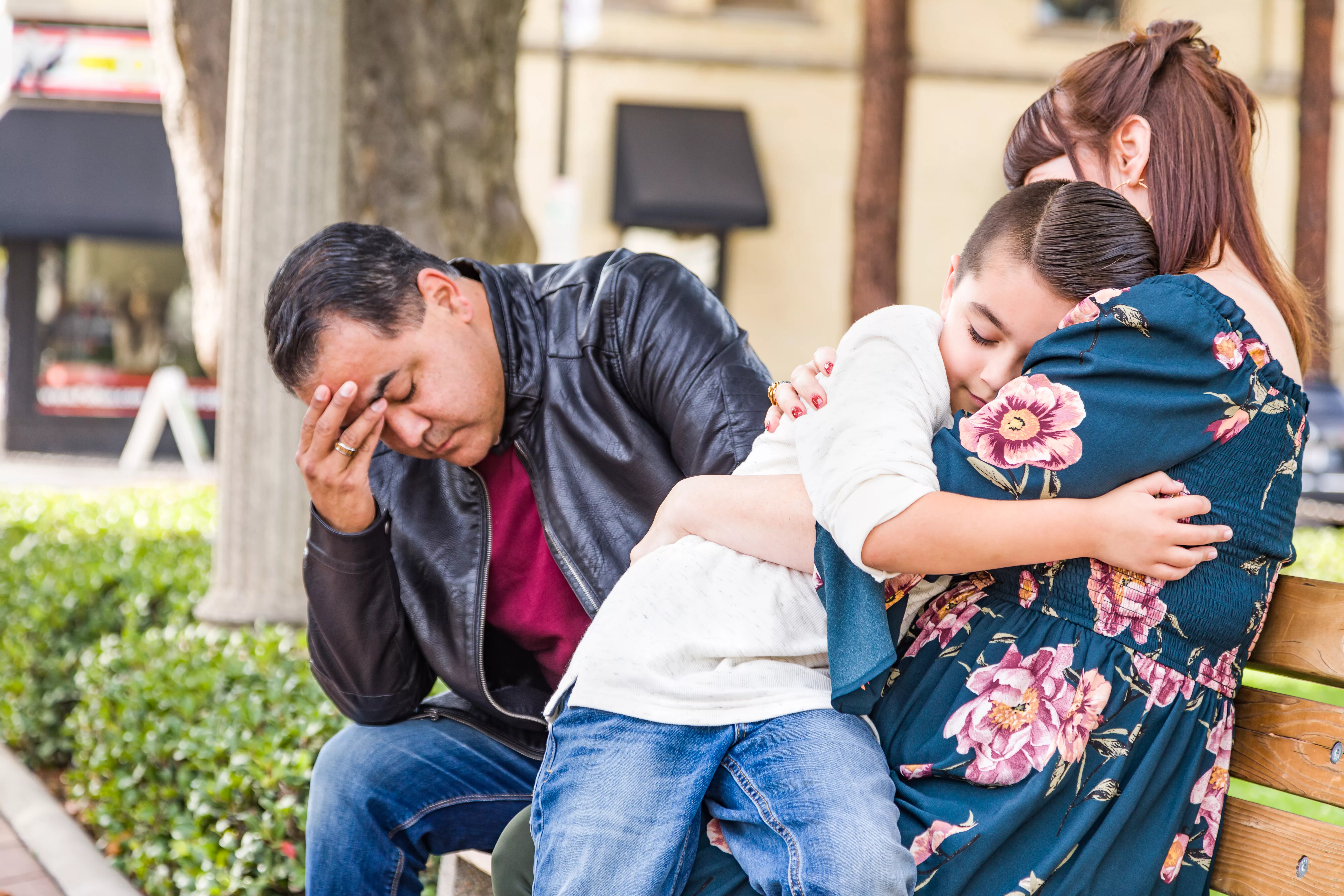 caucasianmotherandhispanicfathercomfortingmixedracesonoutdoors