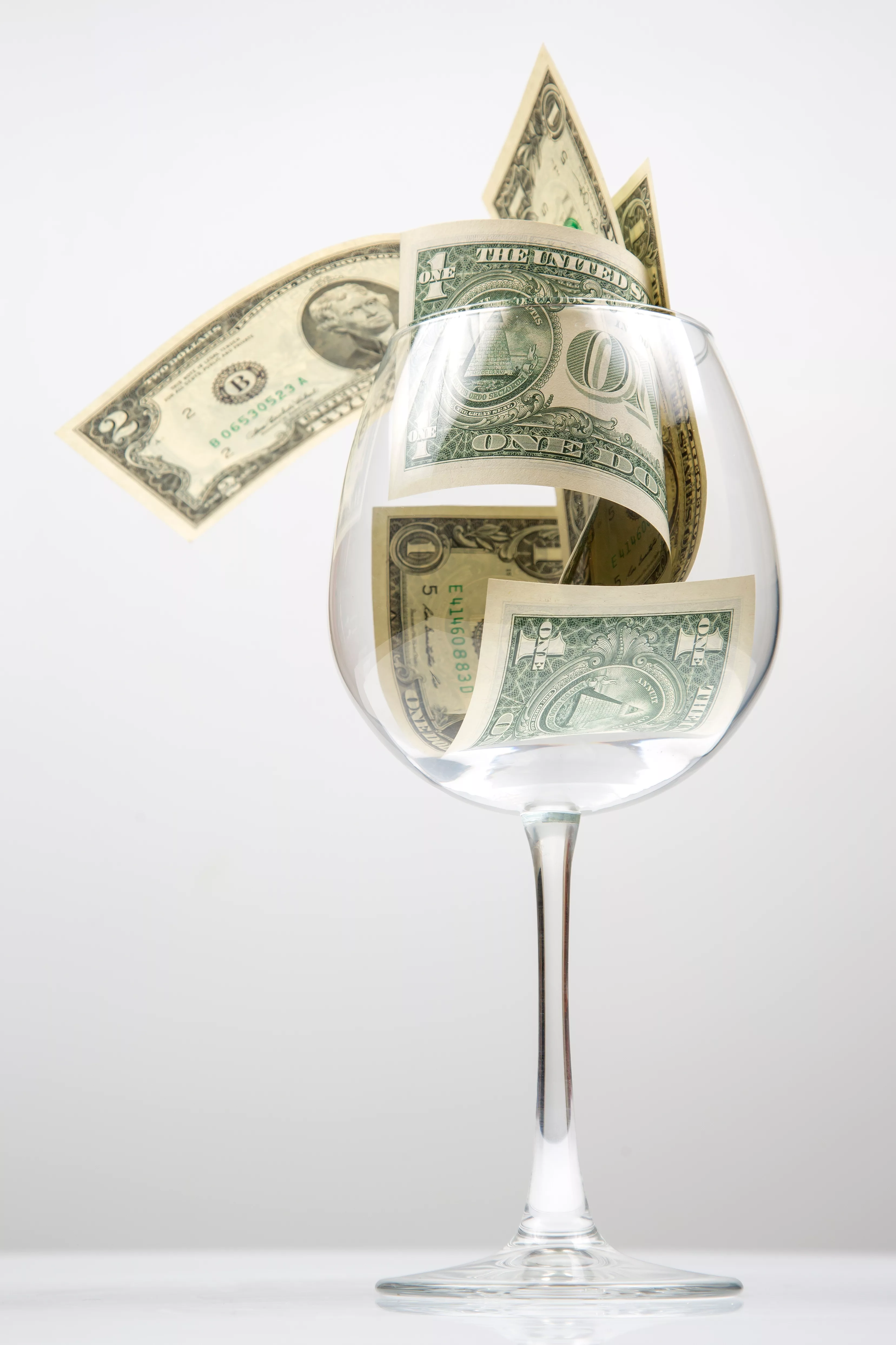 dollarbanknotesmoneyliesinanemptywineglass-business