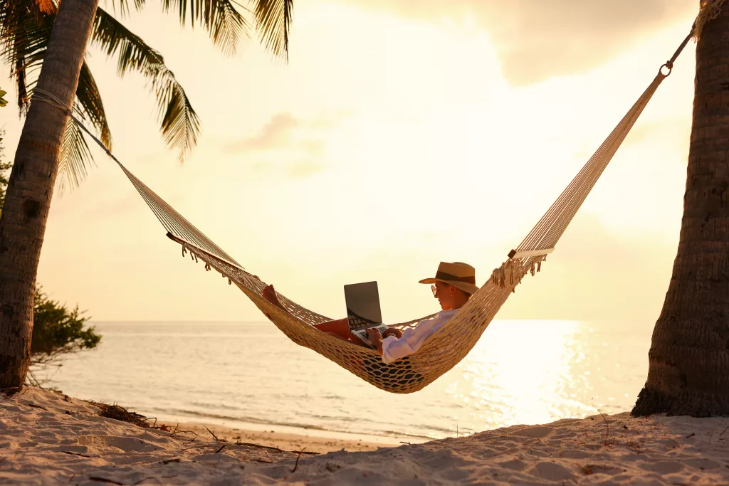 fulllengthofyoungwomansuccessfulfemalefreelancerusinglaptop