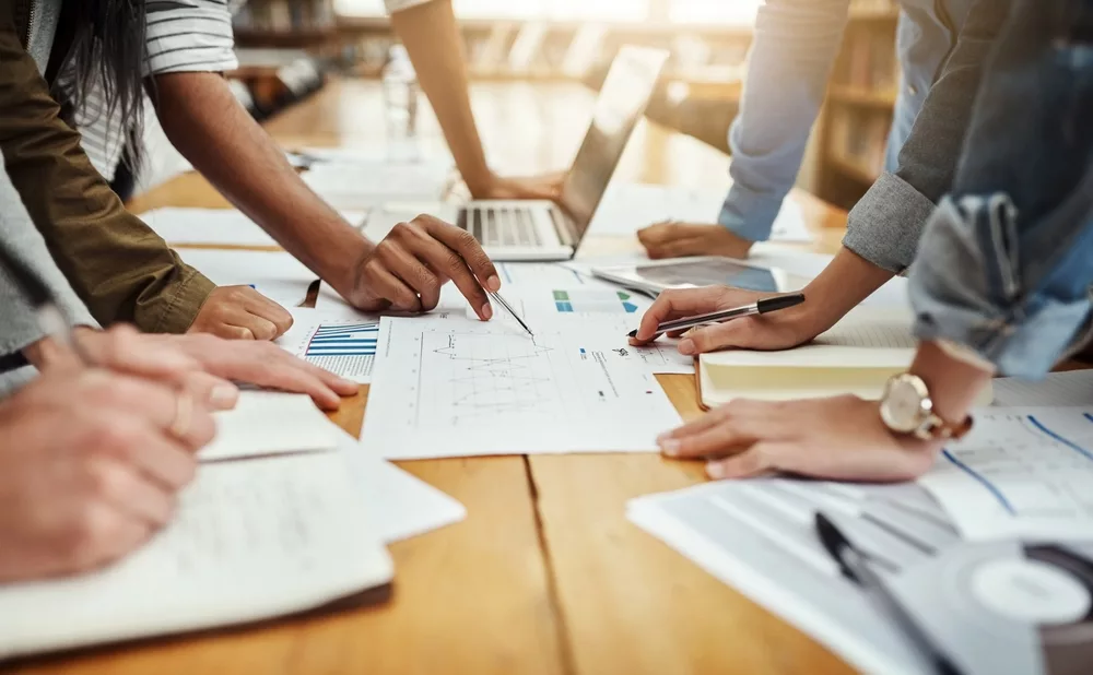 businesspeoplecollaborationandpaperworkwithhandsstatisticsandsocial