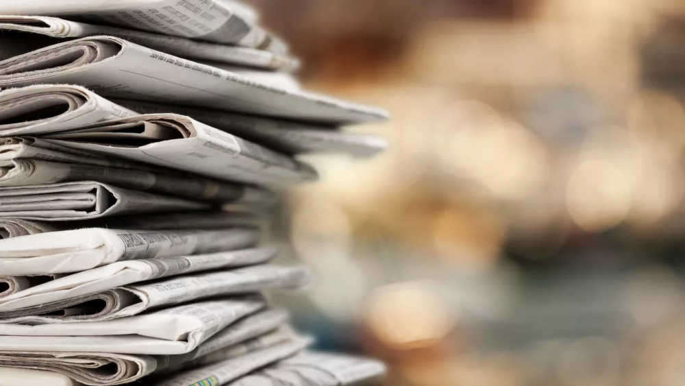 pileofnewspapersstacksonblurbackground