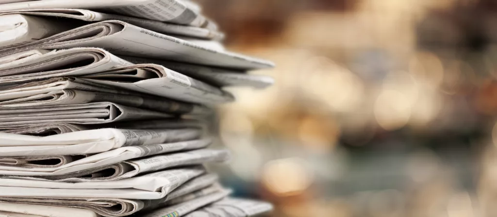 pileofnewspapersstacksonblurbackground