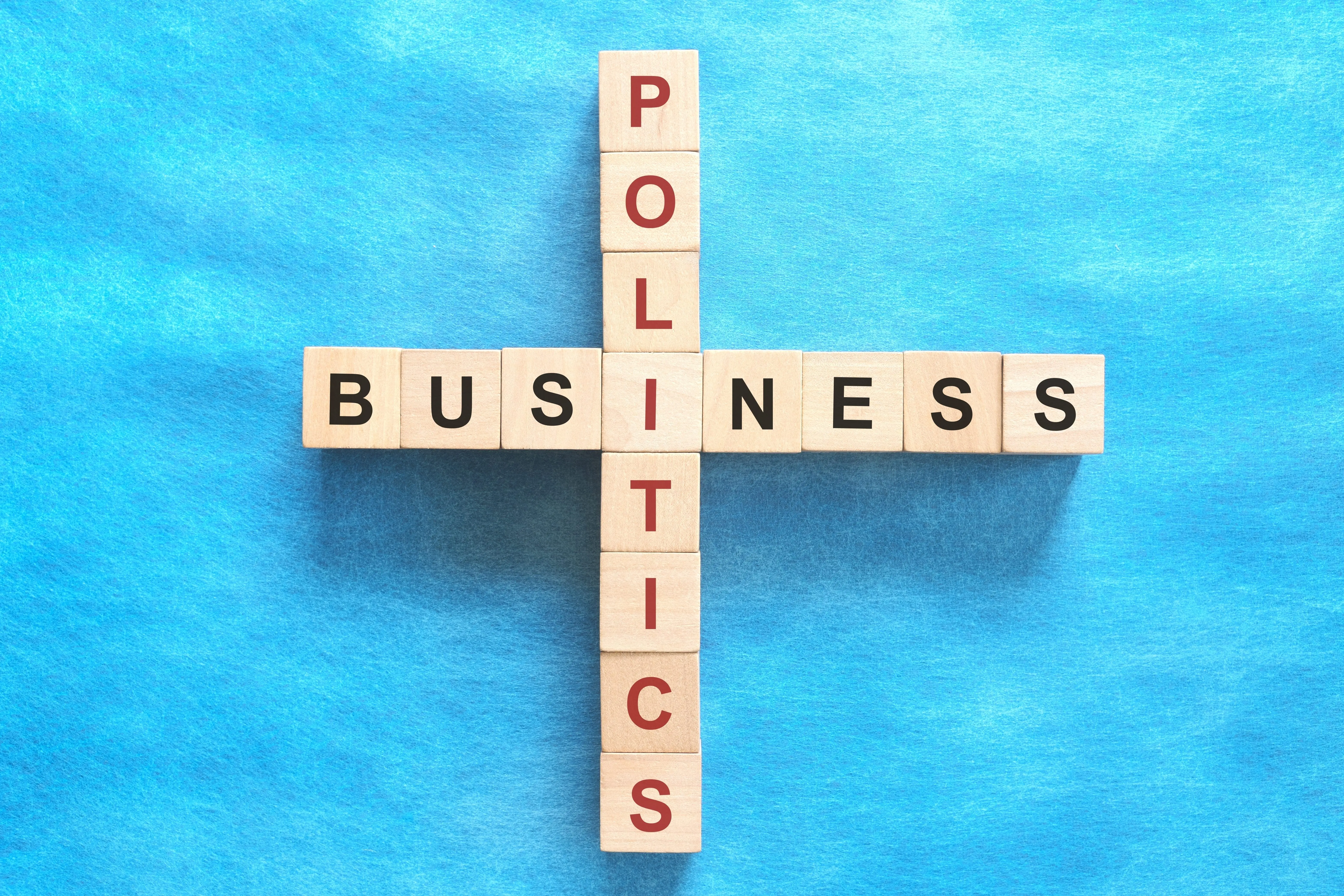 businesspoliticsconcept-crosswordpuzzleflatlayinbluebackground