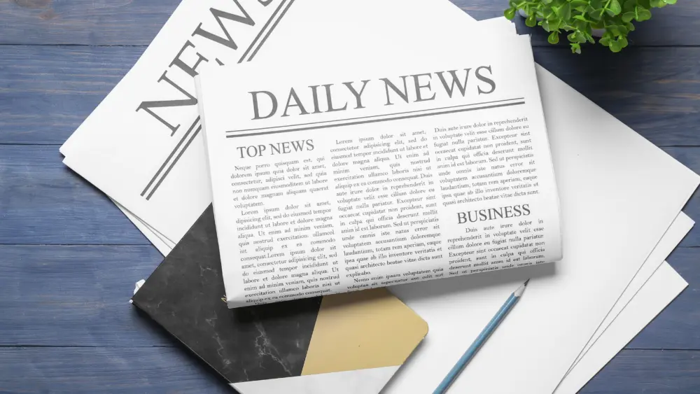 newspaperswithnotebookandpencilonbluewoodenbackground