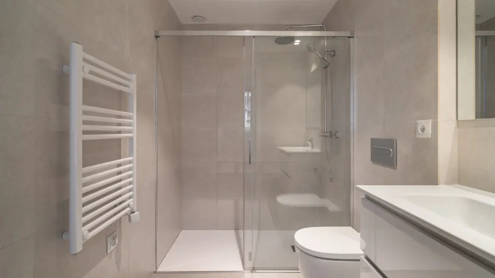 modernbathroomwithaglassshowerwhitetoiletandsleek
