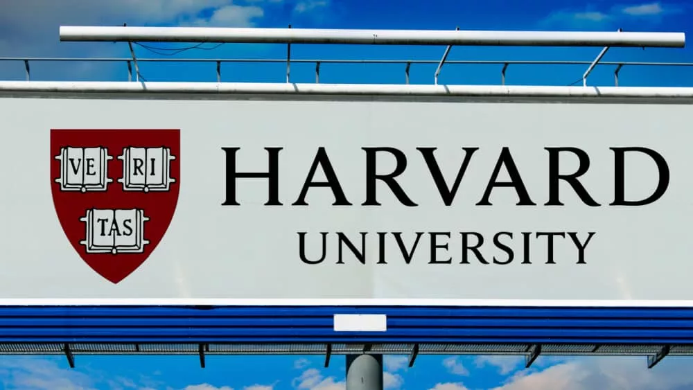 billboard displaying logo of Harvard University^ a private Ivy League research university in Cambridge^ Massachusettsl