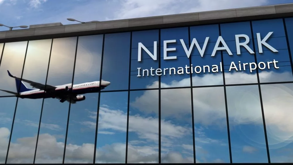 Aircraft landing at Newark^ New Jersey^ USA 3D rendering illustration. Arrival in the city with the glass airport terminal and reflection of jet plane. Travel^ business^ tourism and transport.