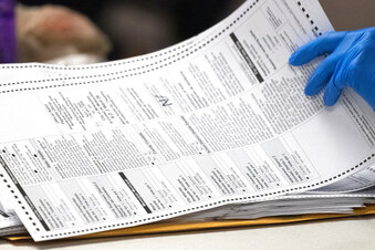 Election 2020 Wisconsin Absentee FILE - In this April 8, 2020, file photo, a City of Milwaukee Election Commission worker processes absentee ballots for the state's primary election, in downtown Milwaukee, Wis. A federal judge has ruled that absentee ballots in battleground Wisconsin can be counted up to six days after the Nov. 3 presidential election as long as they are postmarked by Election Day. (Mark Hoffman/Milwaukee Journal-Sentinel via AP, File)