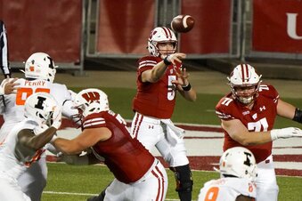 Illinois Wisconsin Football Wisconsin quarterback Graham Mertz throws a pass during the first half of an NCAA college football game against Illinois Friday, Oct. 23, 2020, in Madison, Wis. (AP Photo/Morry Gash)