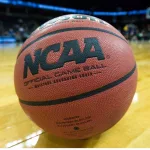 NCAA basketball/game ball sits on court