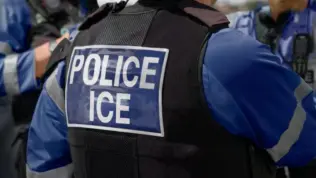 ICE police agent - Officer of Immigration and Customs Enforcement. Close-up of POLICE ICE marking on the back of a stab proof vest uniform worn by a trio of police officers at the scene of an immigrant incident. The ICE federal law enforcement agency is under the supervision of the United States Department of Homeland Security.