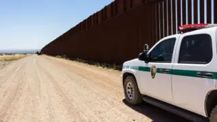 Police car stopped near the border fence of the USA . Arizona^ USA - June 28^ 2016