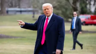 President Donald Trump points while on the South Lawn as he walks into the White House. WASHINGTON – February 22^ 2025
