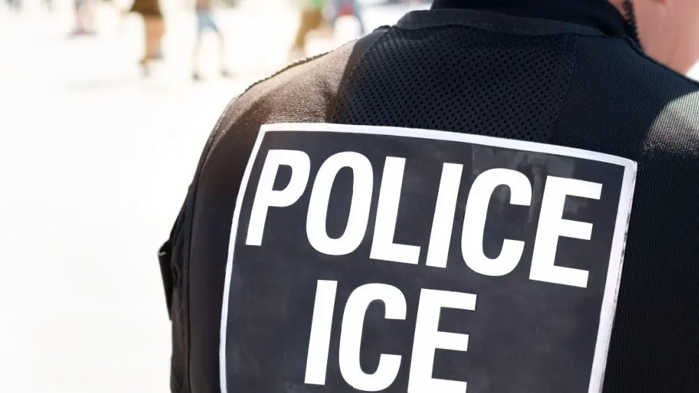 Ice police agent - Officer of Immigration and Customs Enforcement. Close up of POLICE ICE on back of stab proof vest worn by DHS Department of Homeland Security police officer at the scene of incident