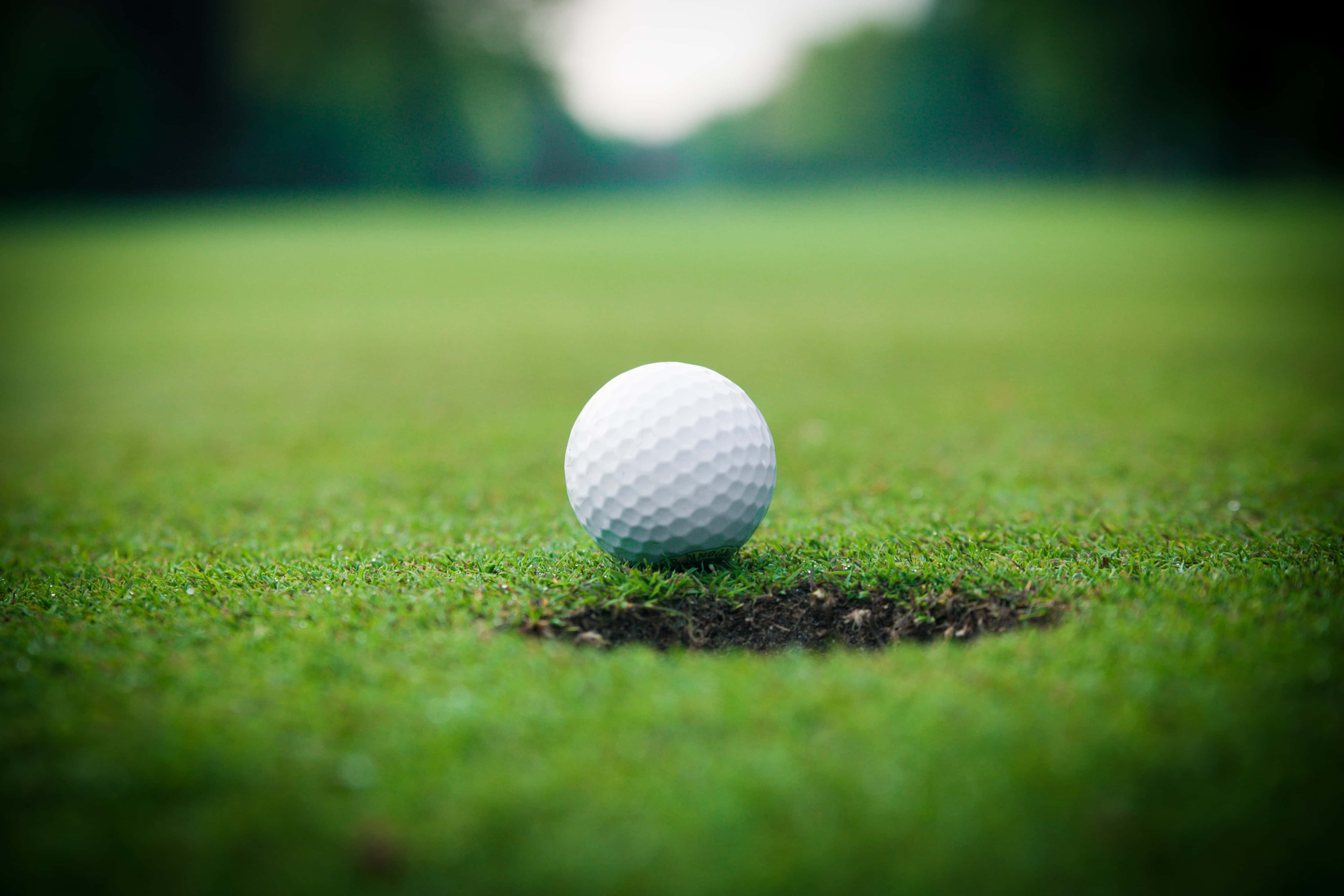 golf-ball-on-lip-of-cup-golf-ball-and-hole