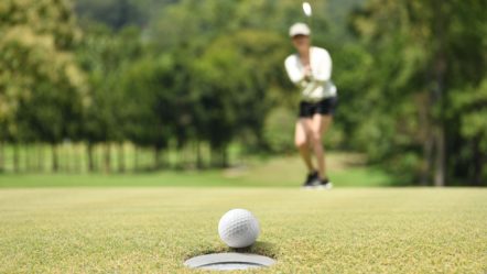 woman-golfer-cheering-after-a-golf-ball-on-a-golf-green