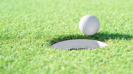 golf-ball-and-golf-hole-on-green-grass-with-copy-space