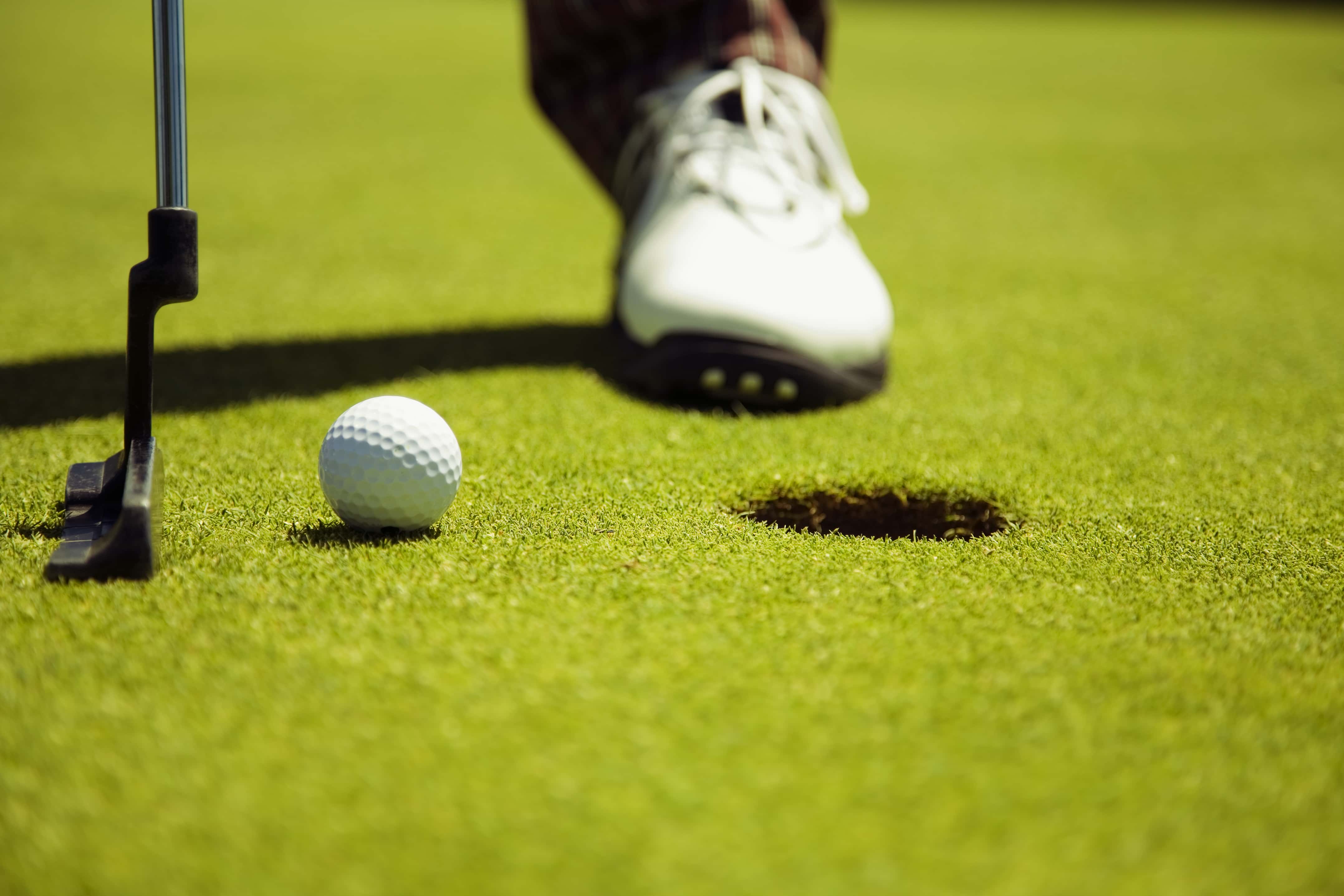 adult-man-playing-and-hitting-golf-ball