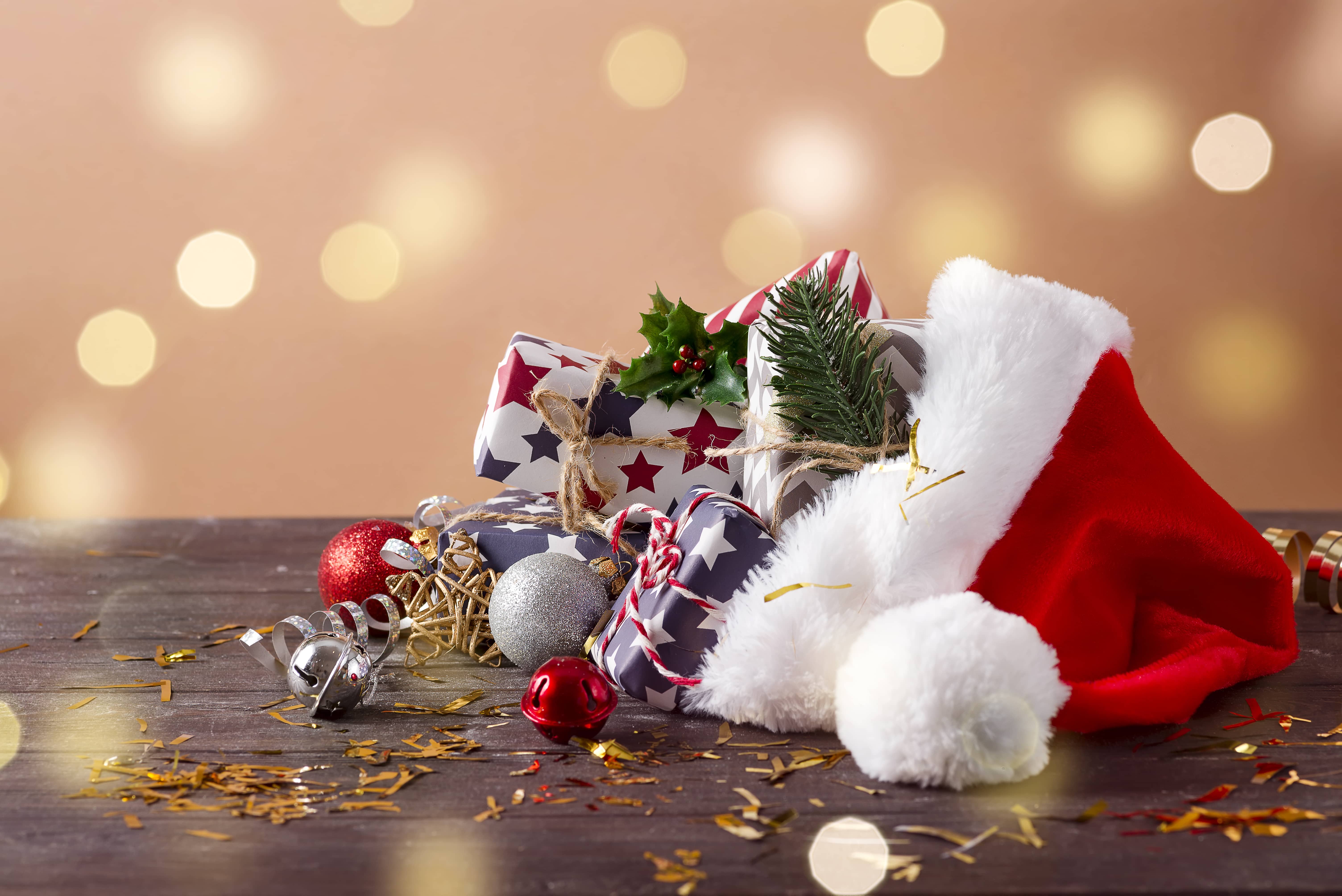 christmas-holidays-composition-with-santa-claus-red-hat-and-gift-boxes-on-wooden-background-4